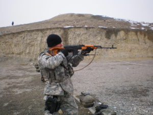 Scott Delius holding rifle at target range